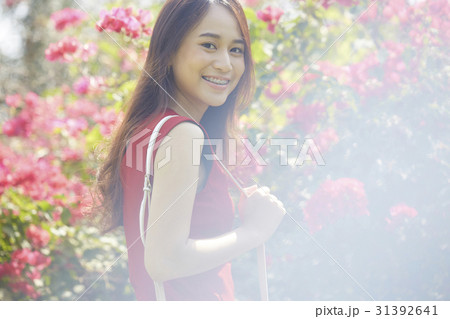 Beautiful happy woman with blossom flowers in garden. Beautiful happy woman with blossom flowers in garden. 31392641