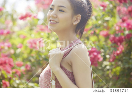 The beautiful girl is in a garden, among trees and flowers 31392714