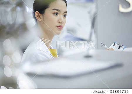 An image of a young doctor looking at something. 31392752
