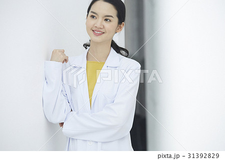A beautiful doctor is folding arms, smiling and standing. A beautiful doctor is folding arms, smiling and standing. 31392829