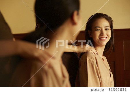 Two women are smiling at each other when they are massaged shoulders. Two women are smiling at each other when they are massaged shoulders. 31392831