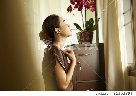 the girl is standing and looking something up. 31392893