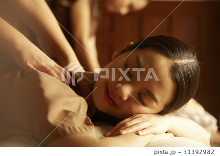 The girl is comfortable and happy when having a massage in spa The girl is comfortable and happy when having a massage in spa 31392982