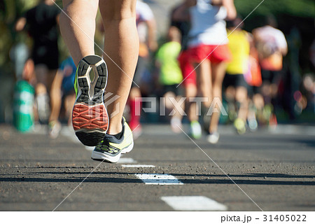 Marathon running race, people feet on city road 31405022