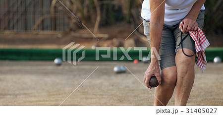 Senior playing petanque, balls on the ground Senior playing petanque, balls on the ground 31405027