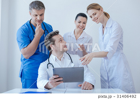 Joyful practitioners testing digital device at 31406492