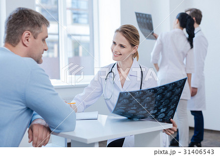 Optimistic neurologist consulting patient in the 31406543