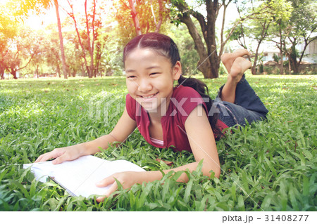 Young cute girl reading a book 31408277