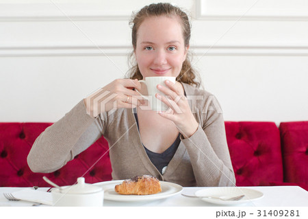 Woman cup of coffee cappuccino croissant breakfast 31409281