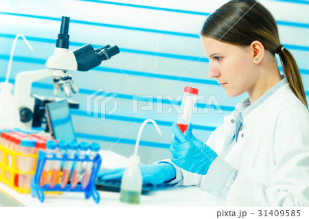 Woman technician with multipipette in genetic Woman technician with multipipette in genetic 31409585