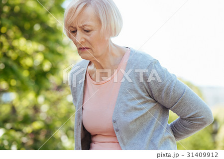 Frustrated pensioner suffering from pain in the 31409912