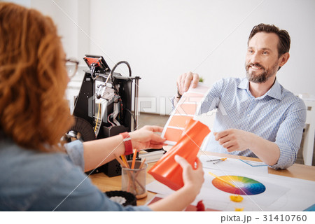 Handsome good looking man helping his colleague to 31410760