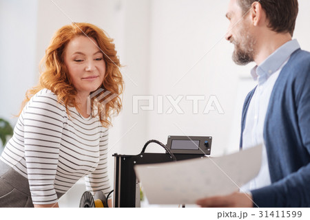 Joyful professional designers discussing their 31411599