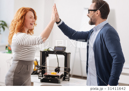 Joyful delighted colleagues giving each other high 31411642