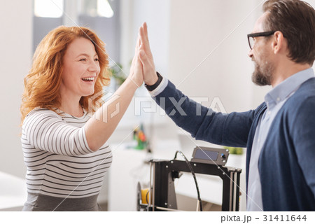 Happy cheerful woman giving his colleague a high 31411644