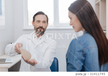 Successful advanced plastic surgeon consulting his 31411745