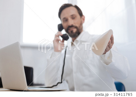 Excited nice doctor talking to his colleague on 31411765