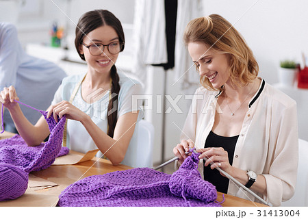 Two pretty tailors socializing while knitting 31413004