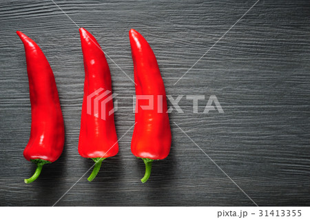 Sweet red Kapia peppers on a dark shale stone 31413355