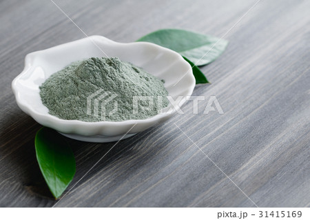 Close-up of a cosmetic dry green clay in a white 31415169