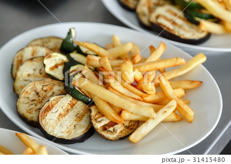 Sliced up vegetables with fries on the table Sliced up vegetables with fries on the table 31415480