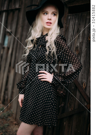 Beautiful attractive girl wearing black hat 31415882