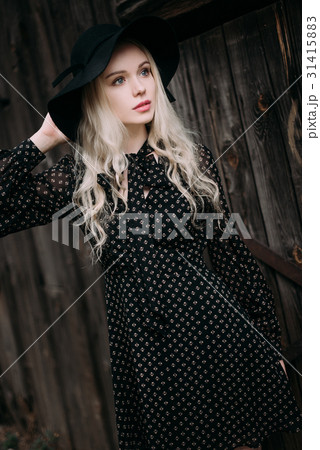 Beautiful attractive girl wearing black hat 31415883