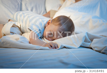 Adorable baby sleeping on big pillow at late night 31416491