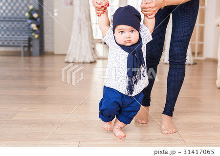 baby taking first steps with mother help baby taking first steps with mother help 31417065