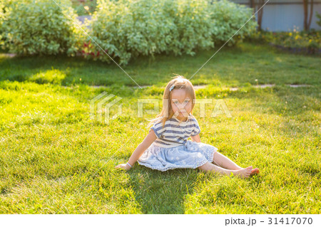 happy child girl playing on meadow in summer in 31417070