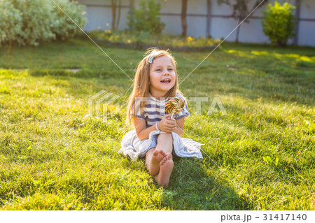 Funny child with candy lollipop, happy little girl Funny child with candy lollipop, happy little girl 31417140