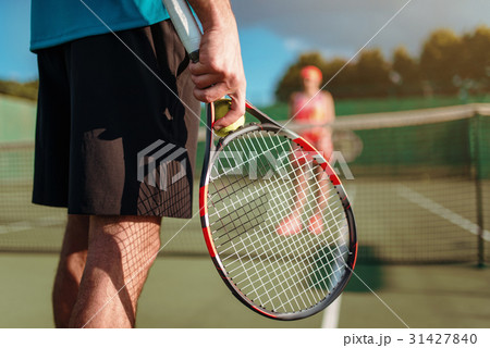 Male and female person playing tennis outdoor Male and female person playing tennis outdoor 31427840