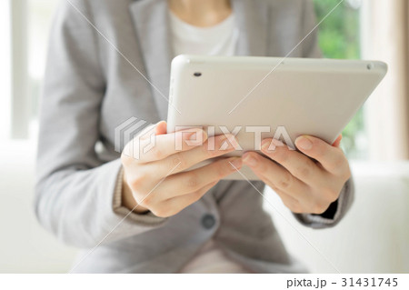 Woman using a tablet computer Woman using a tablet computer 31431745