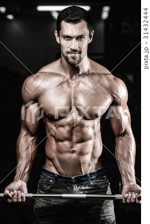 Handsome power athletic man on diet training pumping up muscles Handsome power athletic man on diet training pumping up muscles 31432444