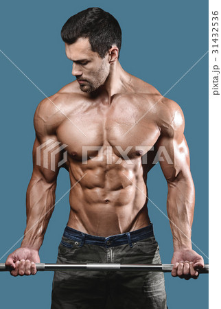 Handsome power athletic man on diet training pumping up muscles Handsome power athletic man on diet training pumping up muscles 31432536