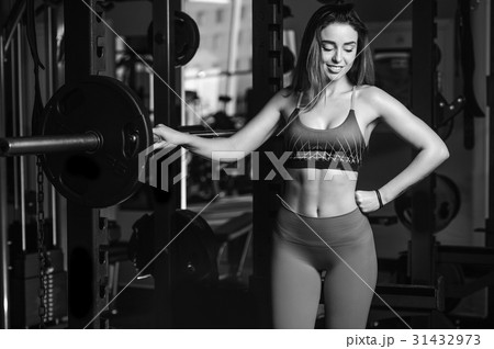 Girl execute exercise with barbell 31432973