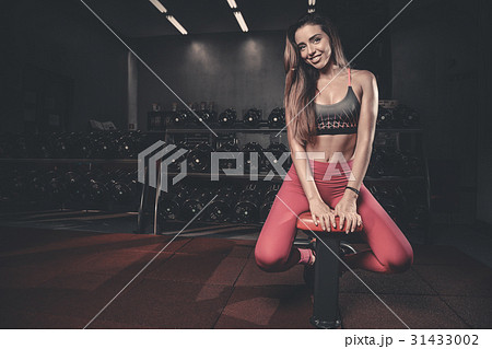 Girl execute exercise with dumbbells . 31433002