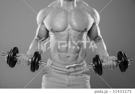 Handsome power athletic man on diet training pumping up muscles Handsome power athletic man on diet training pumping up muscles 31433275