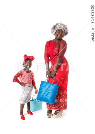 African woman and little girl with tote bags. 31435800