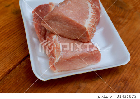 Raw meat pork tenderloin on cutting board Raw meat pork tenderloin on cutting board 31435975