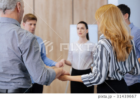 Nice serious people holding hands Nice serious people holding hands 31439667