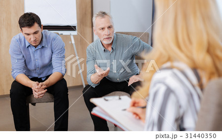 Handsome elderly man looking at his therapist Handsome elderly man looking at his therapist 31440350