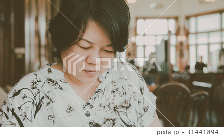 Asian women look menu in coffee shop vintage style 31441894