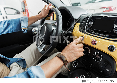Male hand keeping helm in automobile 31444195