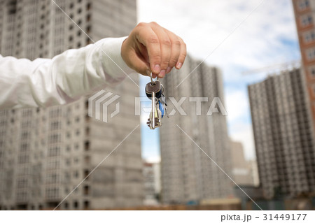 Businessman holding keys from new real estate Businessman holding keys from new real estate 31449177