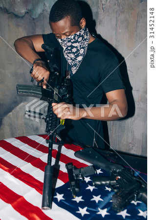 Black warrior is cleaning his rifle Black warrior is cleaning his rifle 31452148