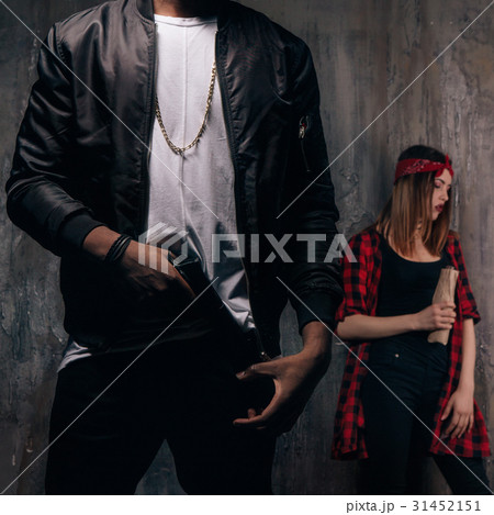 Guy with gun and girl with alcohol 31452151