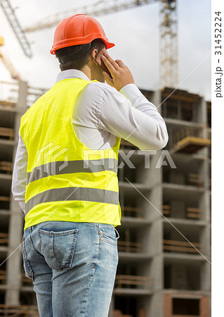 Rear view of businessman in hardhat and vest Rear view of businessman in hardhat and vest 31452224
