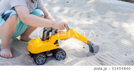 little boy playing with toy excavator 31454840