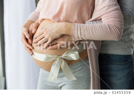Young couple expecting baby standing together 31455359